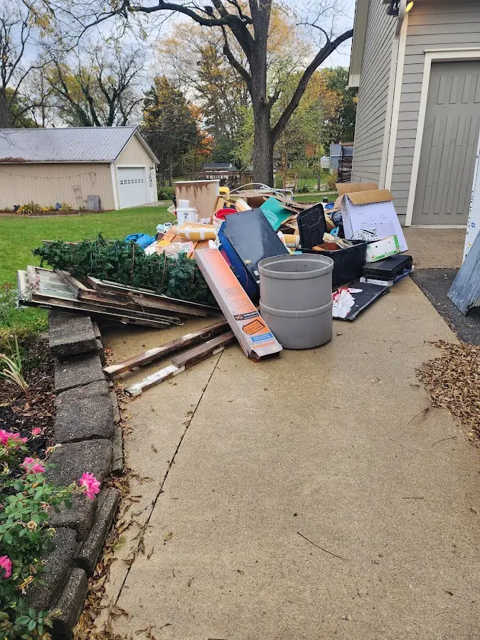 Dumpster being loaded with debris for Roofing Dumpster Rental in Wesley Hills